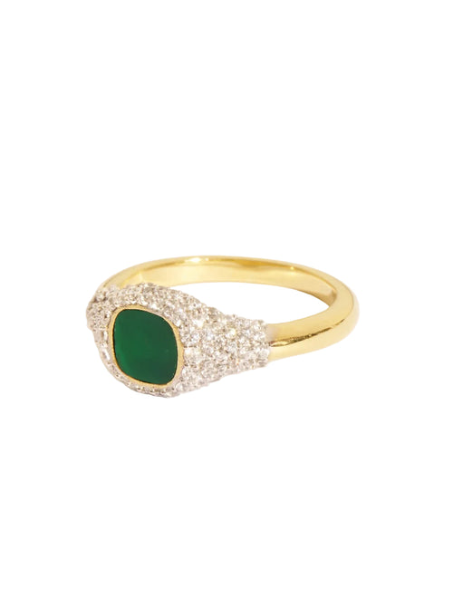 Gold ring with a green gemstone on a white background