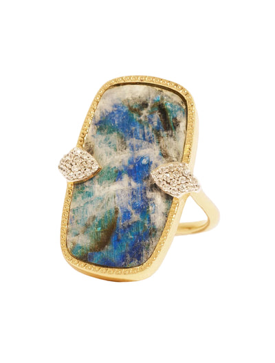 Ring with a large stone and gold accents on a white background