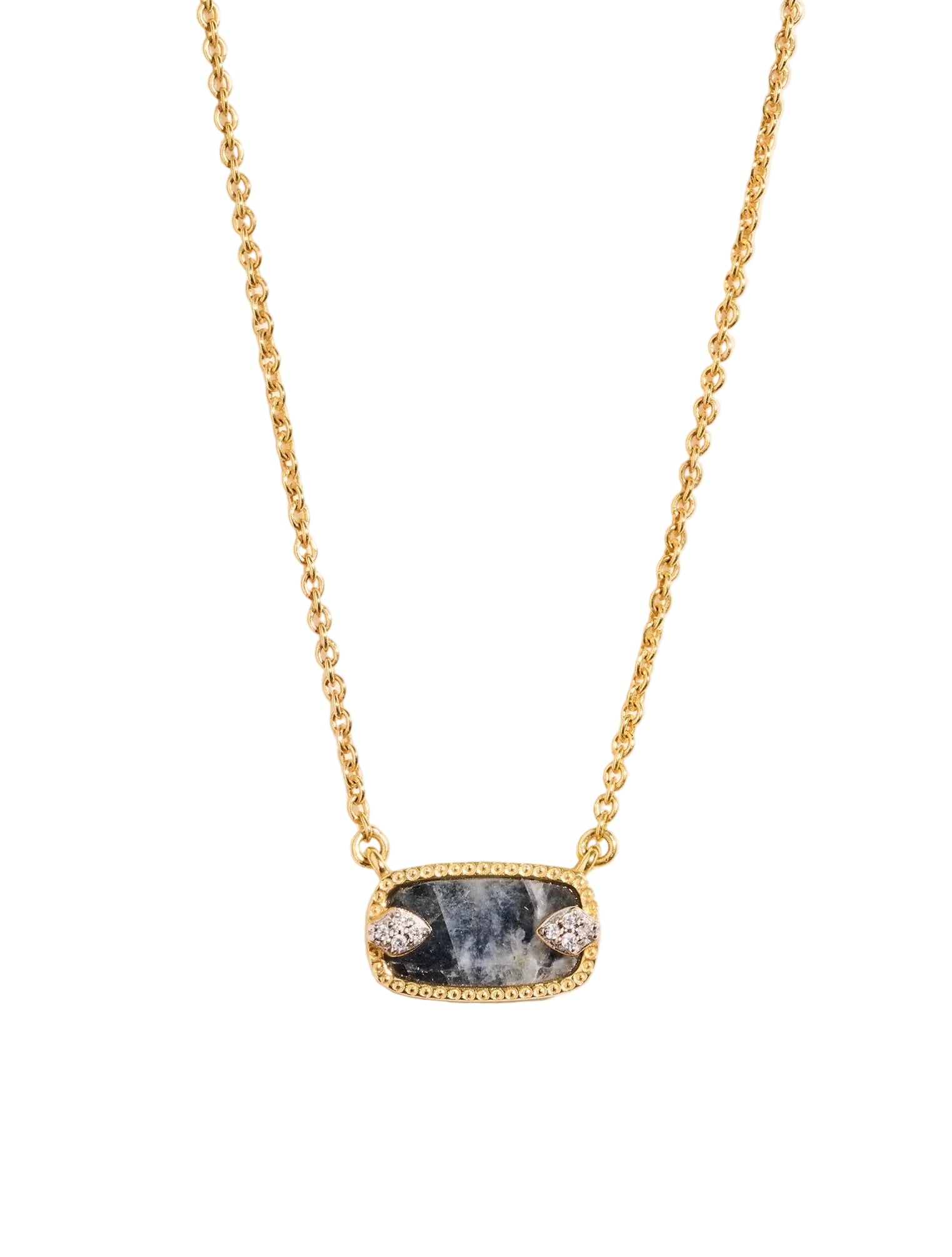 Gold necklace with a dark stone pendant on a light background