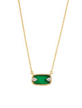 Gold necklace with a green pendant on a white background