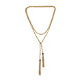 Gold necklace with tassels on a white background